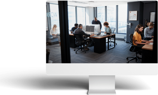 Modern office scene with professionals collaborating in a bright, organized workspace.