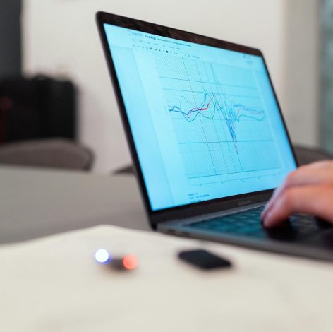 Sleek laptop in minimalist workspace displays data visualization for focused analysis and productivity.