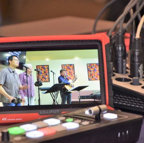 Engaging live music performance with vocal and guitar artists, vibrant lighting, and professional audio equipment.