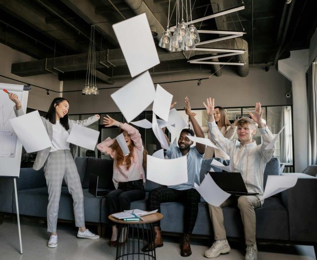 Team triumph in a modern office, celebrating success with joy and excitement.